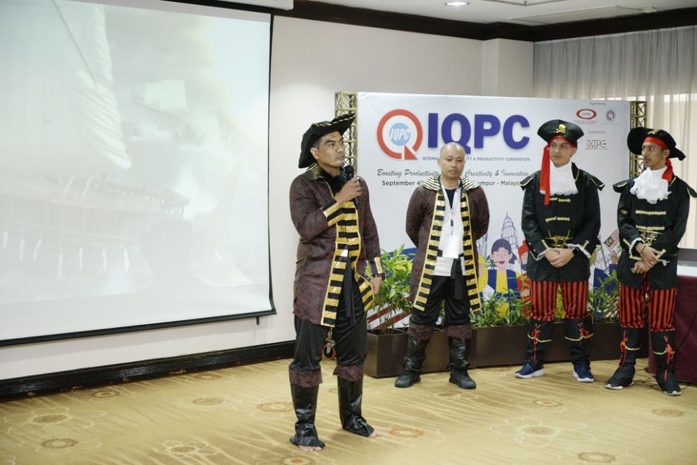 A team presenting in traditional dress during the innovation competition.